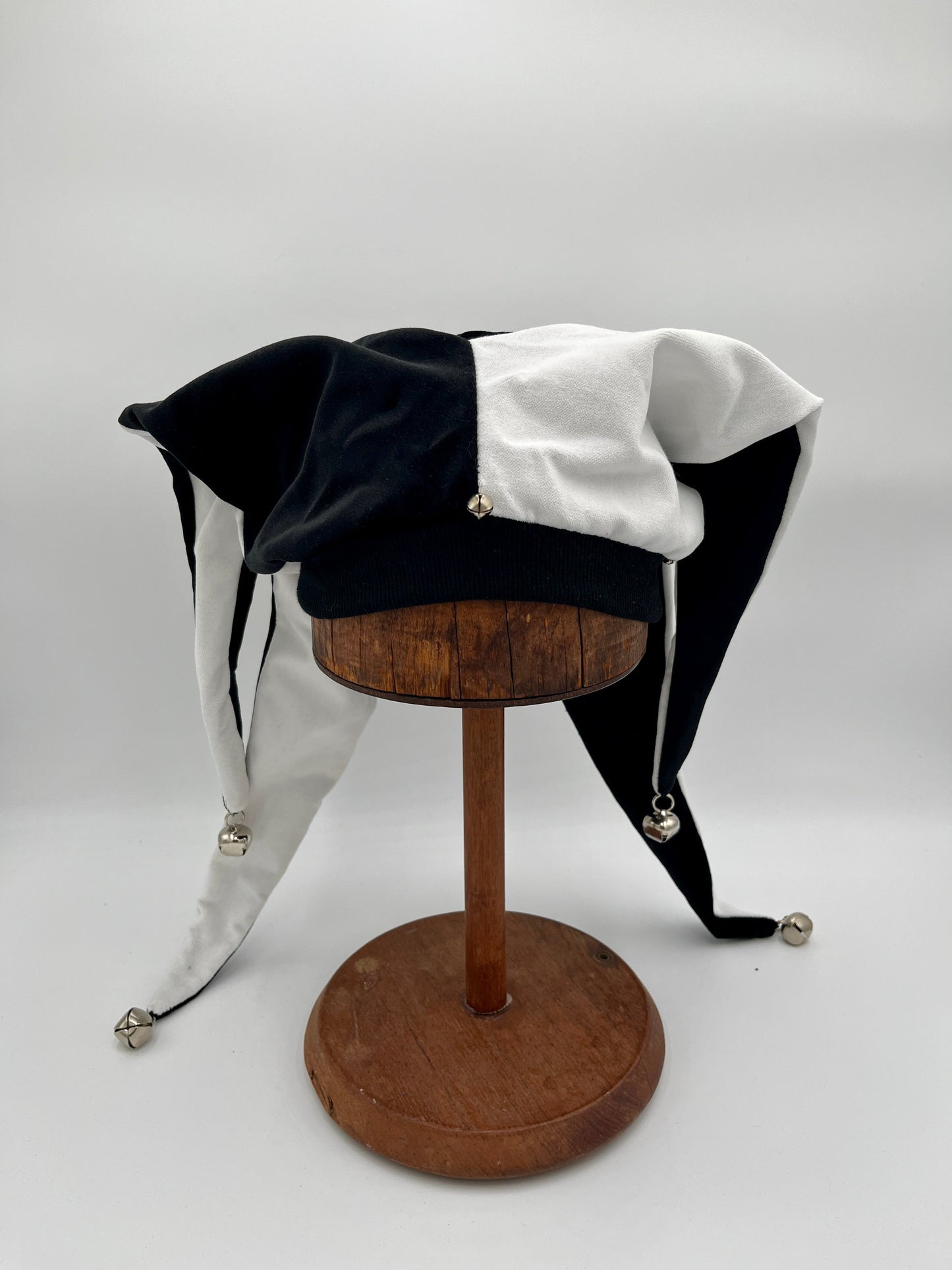 Handmade black white jester hat draped view, close-up of bells
