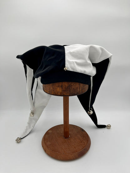 Handmade black white jester hat draped view, close-up of bells